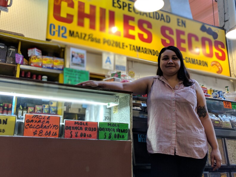 Claudia Armendariz stands in front of Chiles Secos, a stall at Grand Central Market that sells Latino groceries. Her grandfather opened the business in 1975.