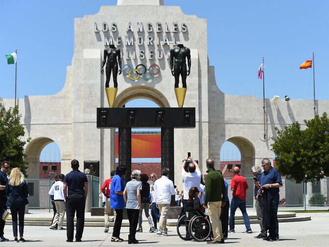IOC Evaluation Commission Chairman Patrick Baumann (C) takes a photograph of the Los Angeles Memorial Coliseum with Los Angeles Mayor Eric Garcetti and LA2024 committee members, IOC Evaluation Commission members, Olympic and paralympics athletes in front of Los Angeles Memorial Coliseum after a venue tour May 11, 2017, in Los Angeles.