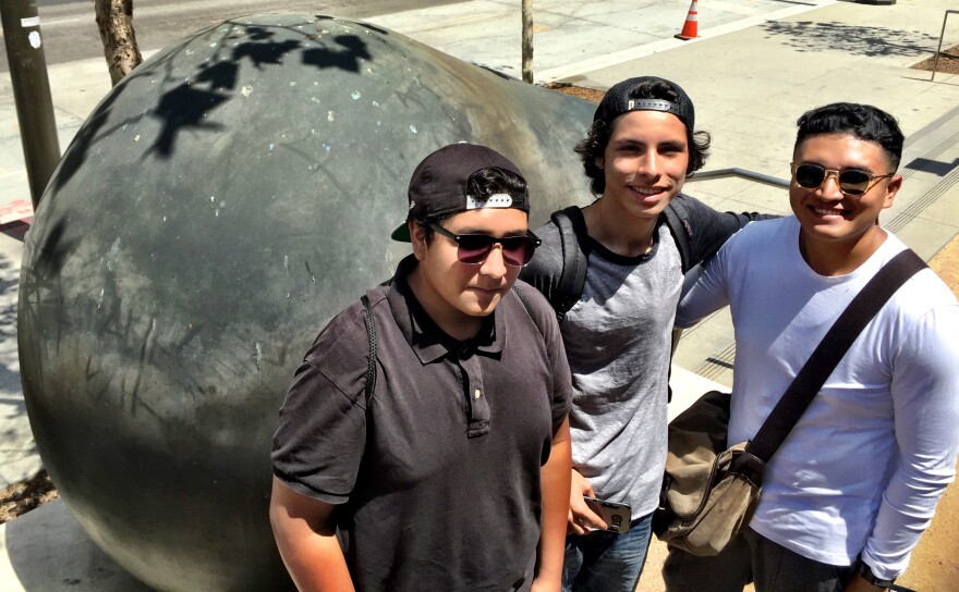 Pokemon Go players Justin Diaz, from Azusa; Steven Chavarria, Hesperia; and Christian Diaz, Azusa, with a piece of public art outside LAPD headquarters.