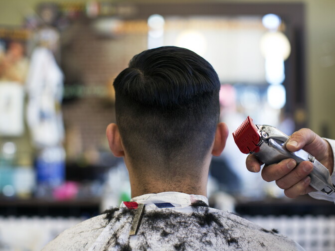 Ruben Rios of Compton receives a haircut at American Barbershop on Fourth Street in downtown Santa Ana on Wednesday, Jan. 14.