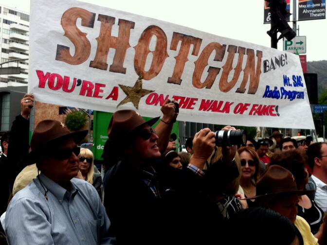 Tammy Trujillo, KPCC newscaster and teacher at Mt Sac, knows how to get her students noticed. That's her in the sunglasses beneath the "OF" as Shotgun Tom Kelly got his star on the Hollywood Walk of Fame. 4/30/2013