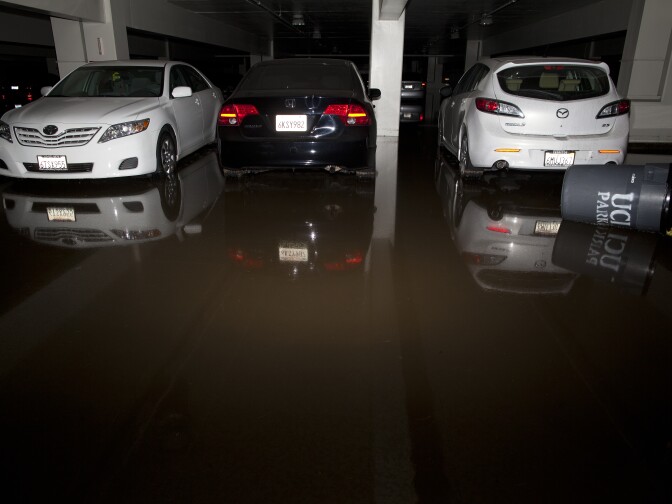 Water begins to recede in the lower levels of a parking garage that was flooded after a water main ruptured on Sunset Boulevard near the UCLA campus.