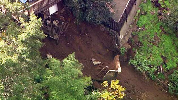 This image made from video provided by KABC-TV shows a slab of concrete that broke away from a home and slid down a rain-soaked hillside in Los Angeles' Hollywood Hills neighborhood Wednesday, Jan. 11, 2016. Some mud and debris fell as far as Laurel Canyon Boulevard below the home, causing the road to be closed. (KABC-TV via AP)