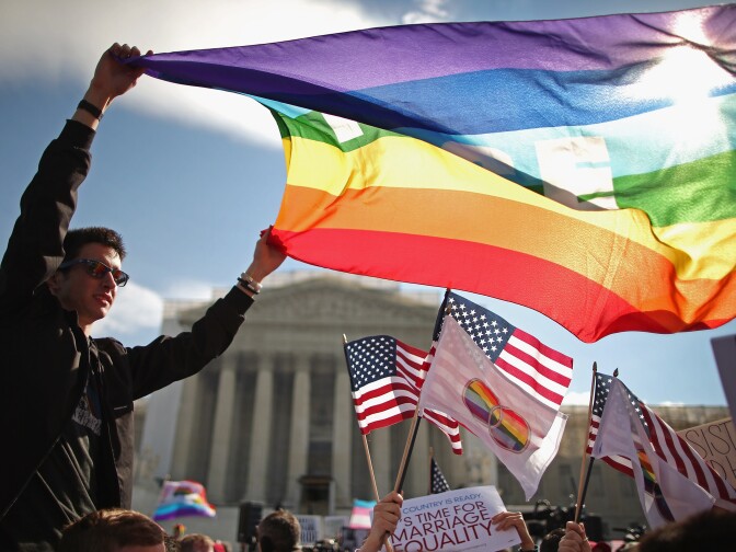 Eric Breese (L) of Rochester, New York, joins fellow George Washington University students and hundreds of others to rally outside the Supreme Court during oral arguments in a case challenging the Defense of Marriage Act (DOMA) March 27, 2013 in Washington, DC. The Supreme Court will hear arguments in the second case this week about same-sex marriage.   