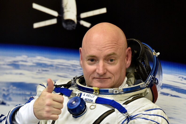 US astronaut Scott Kelly gestures as his space suit is tested at the Russian-leased Baikonur cosmodrome, prior to blasting off to the International Space Station (ISS), late on March 27, 2015. The international crew of US astronaut Scott Kelly and Russian cosmonauts Gennady Padalka and Mikhail Kornienko is scheduled to blast off to the ISS from Baikonur early on March 28. AFP PHOTO / KIRILL KUDRYAVTSEV        (Photo credit should read KIRILL KUDRYAVTSEV/AFP/Getty Images)