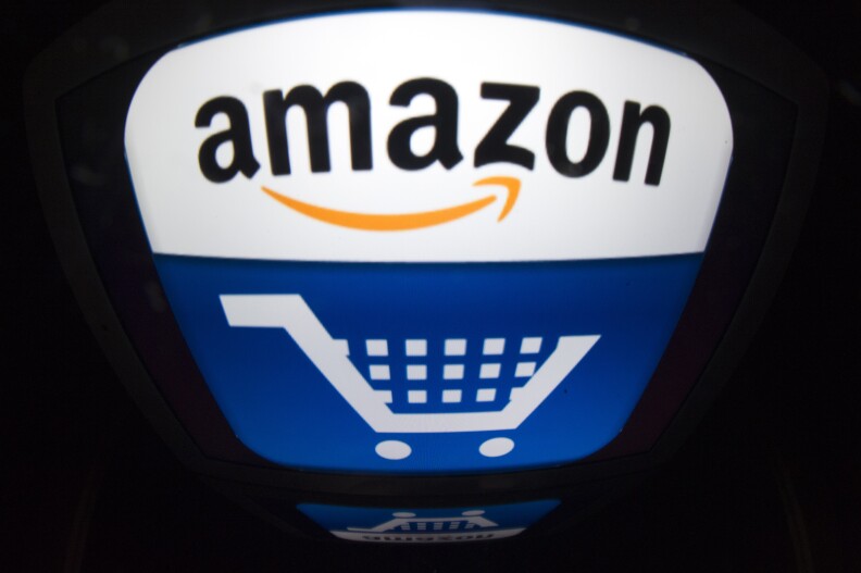 (FILES) - This file picture taken on November 13, 2012 in Paris shows shows the "Amazon" logo. Amazon on October 3, 2013 attacked a French bill which will prevent it from offering free deliveries of discounted books to customers in France as "discriminatory." The online retailing giant also attacked the draft legislation, approved by the lower house National Assembly earlier in the day, as a blow to consumers' spending power.            AFP PHOTO / LIONEL BONAVENTURE