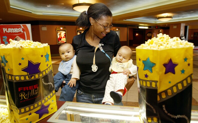 Mother Wanda Cole-Frieman and her twins Taylor and Isaac attend a screening of 'Cold Mountain' at Leows Movie Theater on 34th Street January 6, 2003 in New York City. 