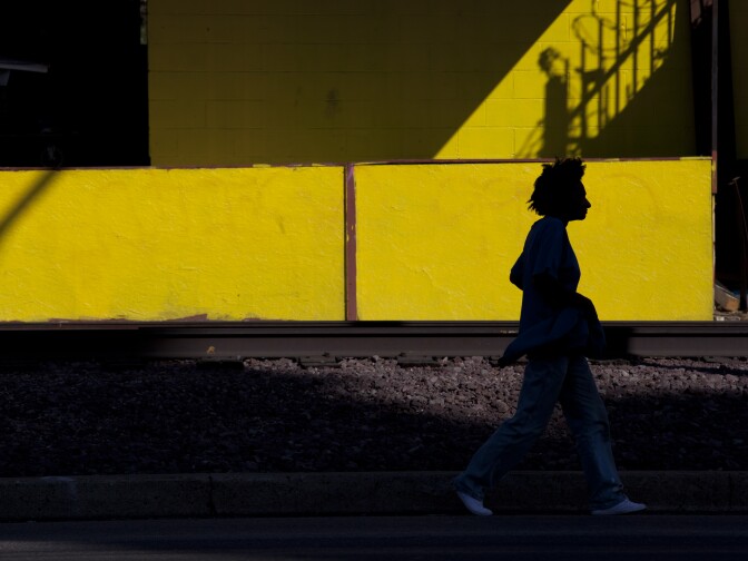 A woman walks along the train tracks on Slauson Avenue. The Metropolitan Transportation Authority is considering turning the eight miles of defunct tracks in a green space for pedestrians and bikers.