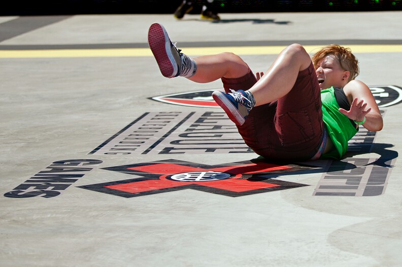 Skateboarder Candy Jaobs falls off her board while attempting a trick during the second heat of the Women's Skateboard Street competition at L.A. Live.