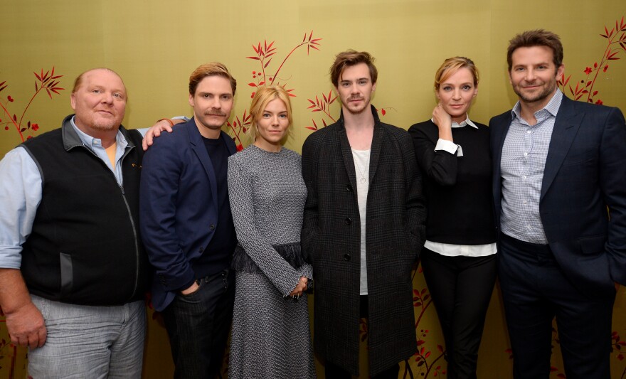 (L-R) Mario Batali, Daniel Bruhl, Sienna Miller, Sam Keeley, Uma Thurman and Bradley Cooper attend the "BURNT" New York Press Conference at The London Hotel on October 20, 2015 in New York City.  