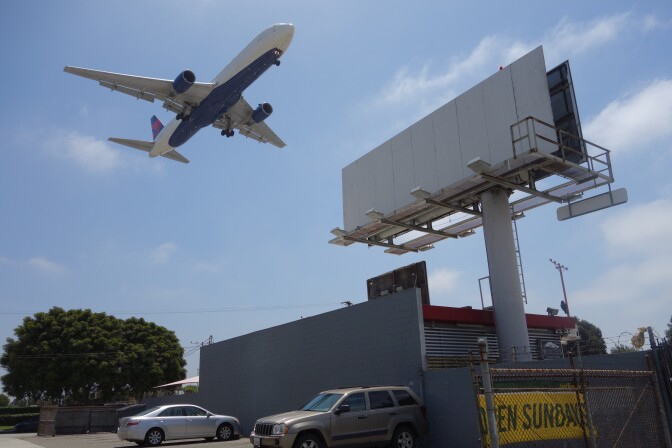                                An airport-adjacent billboard could come down under a new sign ordinance approved for Los Angeles International Airport.