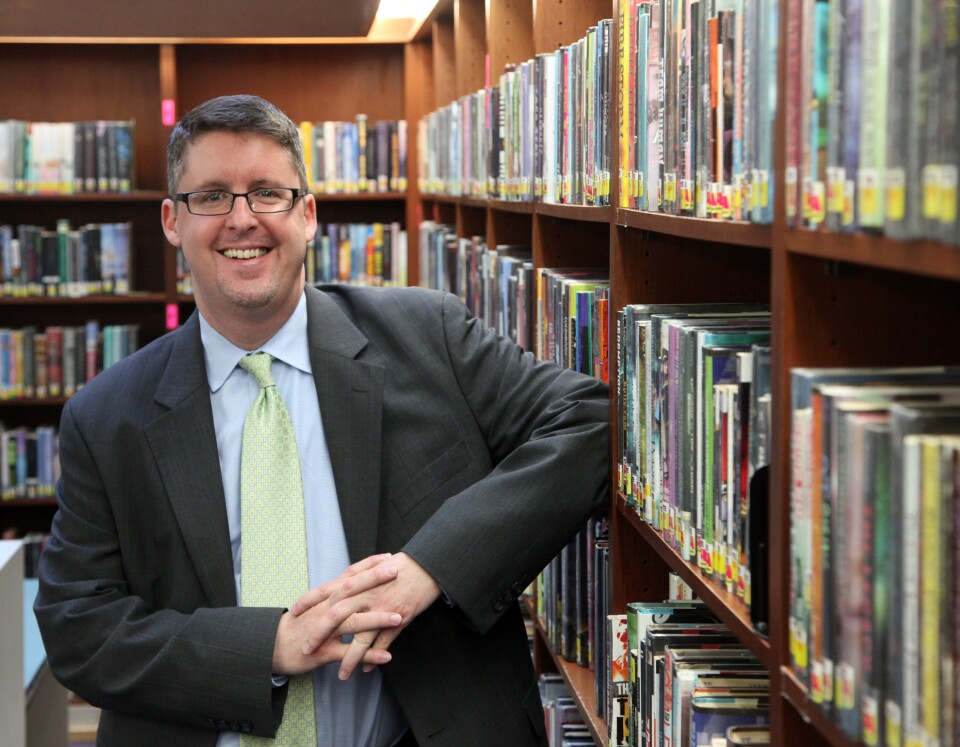 In this Monday, Jan. 6, 2014 photo, Los Angeles Public Library City Librarian John Szabo poses for a photo at the Los Angeles Central Library. People go to the library to read, play computer games, surf the Internet and rent movies. Now residents in Los Angeles can also get an accredited high school diploma there. (AP Photo/Nick Ut)