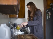 Jess Cullen, who is Australian, washes her dishes on Wednesday morning, May 27, 2015 in her West LA apartment.