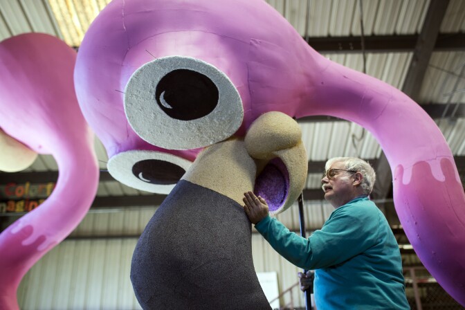 Volunteer David Gaydosh of Hawthorne patches poppyseed onto a bird beak at Sierra Madre Rose Float Association's barn on Tuesday morning, Dec. 29, 2015. The birds are part of a float for the 2016 Rose Parade on New Year's Day.