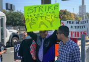 A protestor strikes for higher wages at Uber's Redondo Beach offices.
