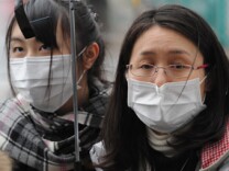 People queue up for buses at a station to get out of the city in Yamagata, Yamagata prefecture on March 15, 2011.