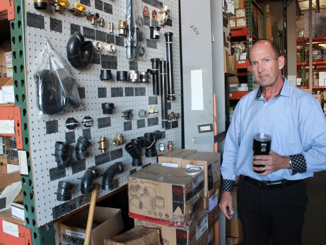 20/20 Plumbing and Heating vice president Mike Mahony walks through the company’s warehouse, October 16, 2019. 
