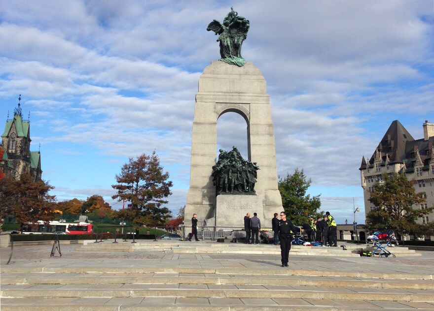 This October 22, 2014 photo shows police at the scene of a shooting at the National War Memorial in Ottawa, Canada. Parliament Hill's Centre Block is in lockdown after a Canadian soldier standing guard at the National War Memorial in Ottawa was shot by an unknown gunman and there are reports of gunfire inside the halls of Parliament.