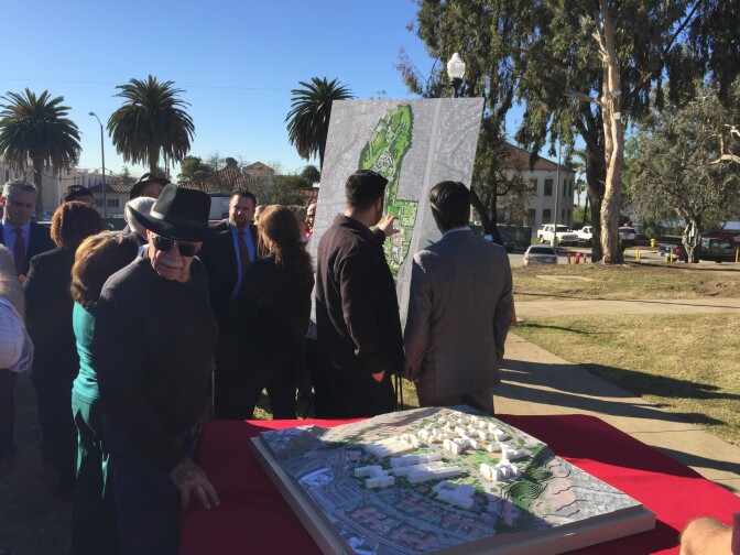 Attendees inspect new models depicting possible upcoming renovations to the 388-acre Westwood veterans campus.