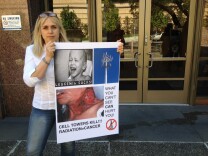 Liz Barris of Topanga Canyon believes radio frequency emissions from new emergency communications towers are dangerous. She displays  a sign outside the LA County Board of Supervisors meeting.