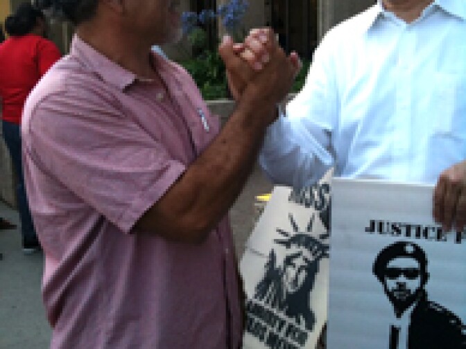 Chicano anti-war activist Carlos Montes joins his supporters outside the L.A. County courthouse in Alhambra, where he pled not-guilty to gun charges.
