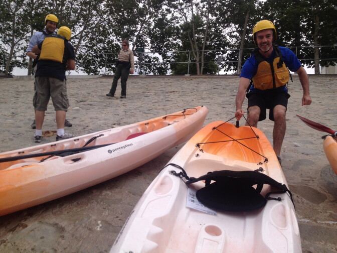 L.A. City Councilman Mitch O'Farrell helps pull up a kayak at Marsh Park. Elysian Valley hosts one of two recreation zones along the Los Angeles River this summer. 