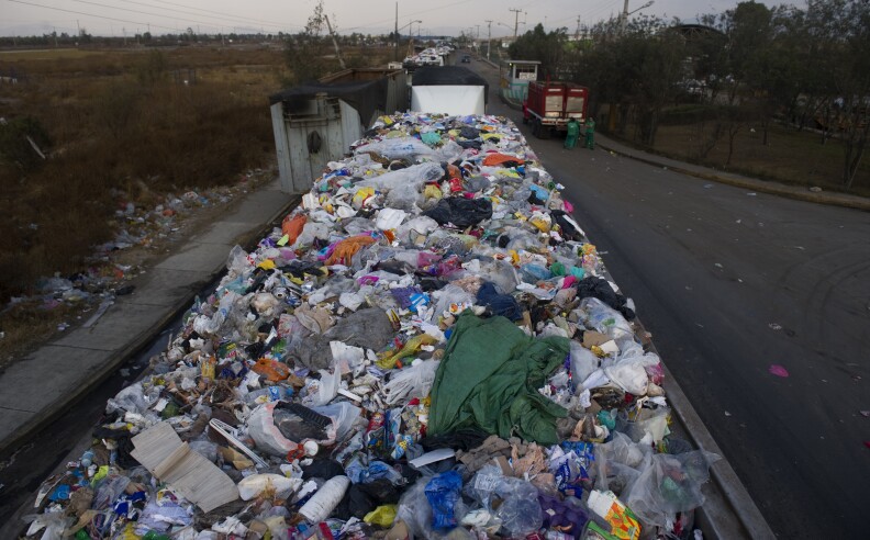This file photo taken on January 18, 2012 shows lorries with refuse lining up to unload at the "Bordo Poniente" garbage dump in Mexico City.  