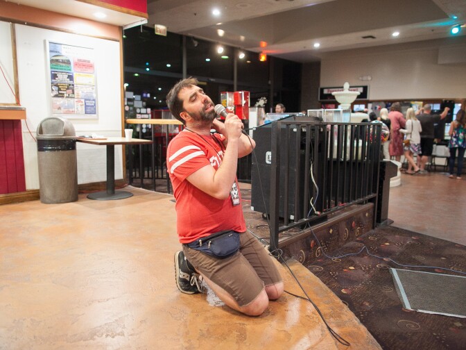Will Russell, one of the founders of Lebowski Fest, croons to his audience at Fountain Bowl in Fountain Valley, Calif. on Saturday, Mar. 14, 2015.
