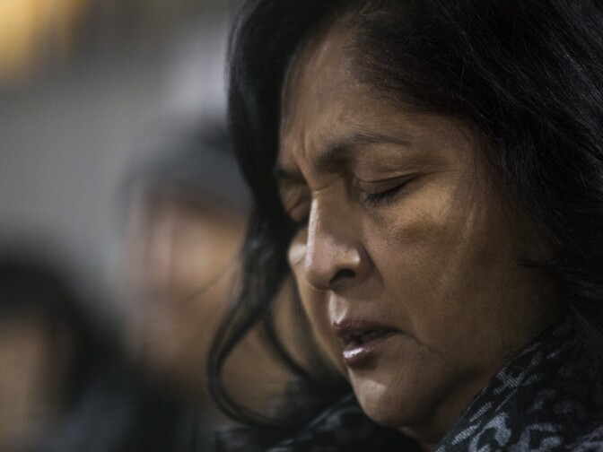 Debbie Villa of San Bernardino takes part in a prayer led by Bishop Gerald Barnes during a vigil at San Manuel Stadium in San Bernardino on Thursday night, Dec. 3, 2015 following a mass shooting that left 14 people dead and 21 injured on Wednesday at the Inland Regional Center.
