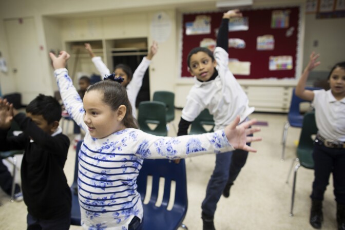 First graders Valeria Beltran, left, and Jarret Moore take part in a music class at Martin Luther King Elementary School in Compton on Friday morning, Dec. 5, 2014. The class is supported by Turnaround Arts, a national program that brings arts education to high-poverty elementary and middle schools.