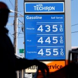 Gas prices are displayed as a motorcyclist pumps gas into his motorcycle at a Chevron gas station on March 1, 2013 in San Francisco, California.  The California Board of Equalization voted on Thursday to implement a statewide excise tax on gasoline starting July 1 that will increase the tax by 3.5 cents to 39.5 cents per gallon. 