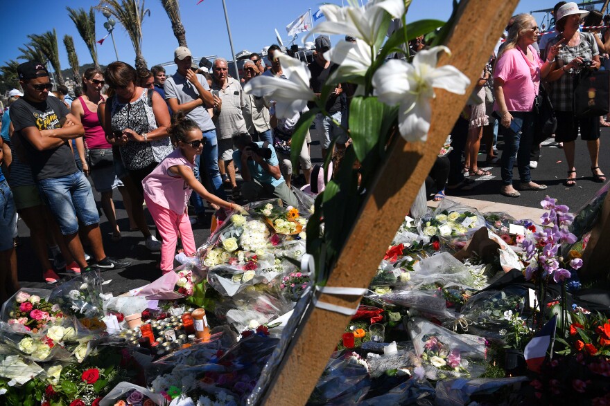 NICE, FRANCE - JULY 15:  People visit the scene and lay tributes to the victims of a terror attack on the Promenade des Anglais on July 15, 2016 in Nice, France. A French-Tunisian attacker killed 84 people as he drove a lorry through crowds, gathered to watch a firework display during Bastille Day Celebrations. The attacker then opened fire on people in the crowd before being shot dead by police.  (Photo by David Ramos/Getty Images)