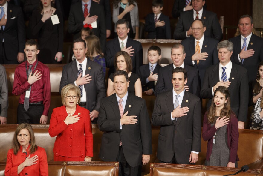 Members of the House of Representatives, many with their families, stand for the Pledge of Allegiance as they gather for the opening session of the 114th Congress on Capitol Hill in Washington, Tuesday, Jan. 6, 2015. House Speaker John Boehner of Ohio, is expected to win a third despite a tea party-backed effort to unseat him, and Sen. Mitch McConnell, R-Ky., ascends to majority leader of the Senate after Democrats lost control the wake of November's midterm elections  (AP Photo/J. Scott Applewhite)