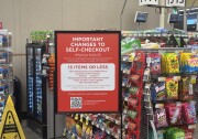 A sign in a supermarket stating "Important changes to self-checkout" followed by a list of rules.