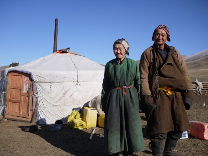 Nomadic herders Lkhagvajav Bish, 90, and her son, Tsahiur Rentsenkhorloo, stand outside their ger in northeastern Mongolia. "All I can do is watch my grassland disappear," says Bish.