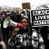 BROOKLYN CENTER, MN - APRIL 13: Protesters march outside the Brooklyn Center police headquarters on April 13, 2021 in Brooklyn Center, Minnesota. Demonstrations have become a daily occurrence since Daunte Wright, 20, was shot and killed by Brooklyn Center police officer Kimberly Potter on Sunday. Photo by Stephen Maturen/Getty Images)