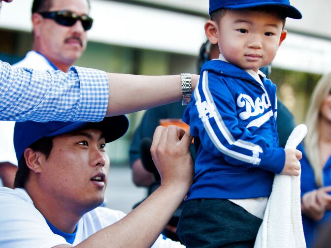 Ryu signs the jacket of 2-year-old Blake Sunwoo, named after retired Dodger third baseman Casey Blake.
