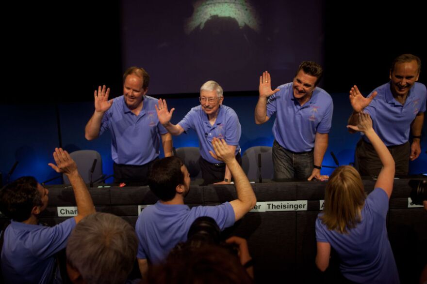 Members of the project leadership team pass out high fives to engineers from mission control before a press conference at the Jet Propulsion Laboratory Sunday night.
