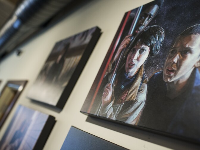 Artist Kyle Lambert created the "Stranger Things" poster and these paintings displayed on the walls of 21 Laps Entertainment.