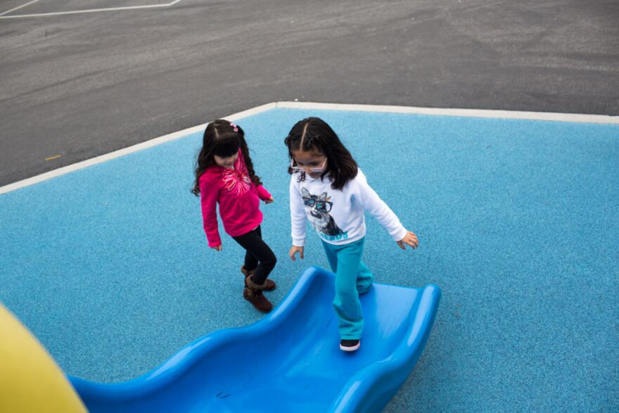 Vanessa Delgado and Ashley Vargas play during recess at Martha Escutia Primary Center, which offers transitional kindergarten.