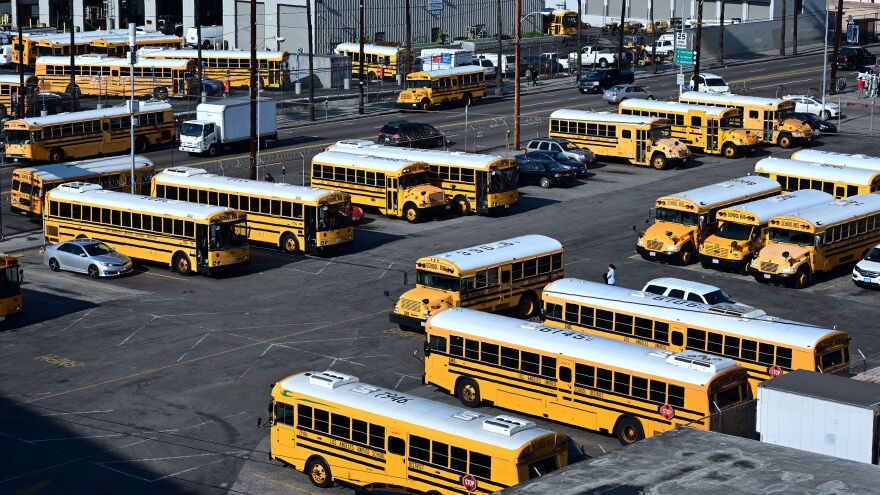A woman walks across a Los Angeles Unified School District school bus parking lot in Los Angeles, California on January 10, 2019. - A judge has rejected the school district's claim it was not given enough notice of a teacher's strike, allowing the teacher's union to potentially walkout on January 14, 2019 for the first strike in 30 years in the country's second largest school district. (Photo by Frederic J. BROWN / AFP)        (Photo credit should read FREDERIC J. BROWN/AFP/Getty Images)