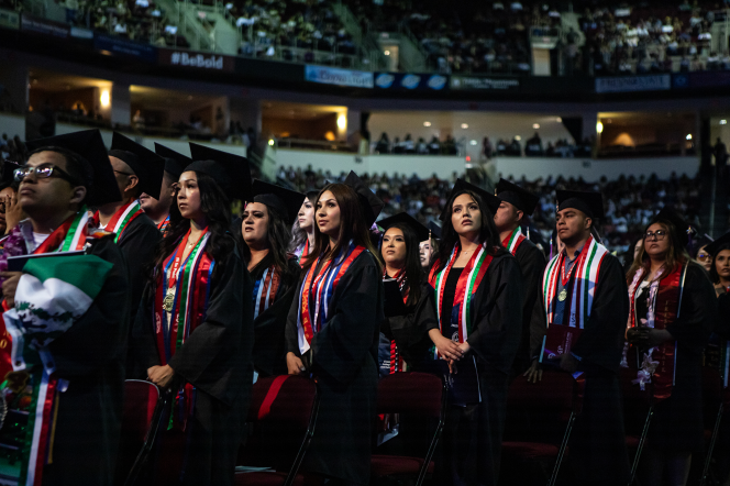 People in graduation cap and gown attire