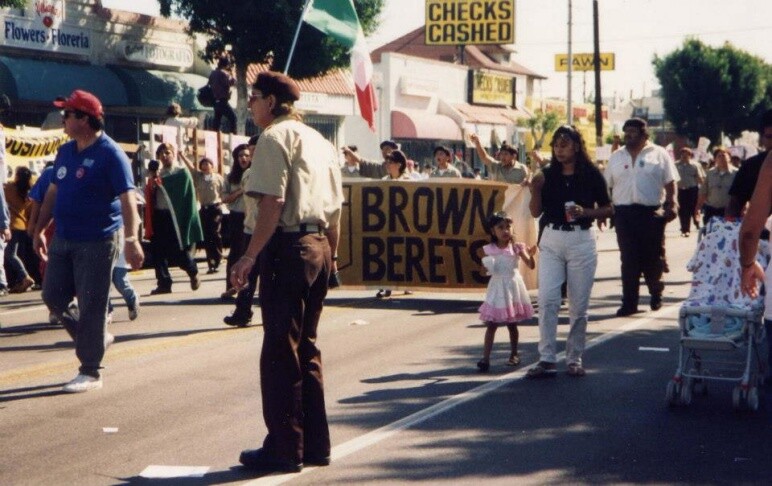 People walk carring a sign that reads: "Brown Berets"