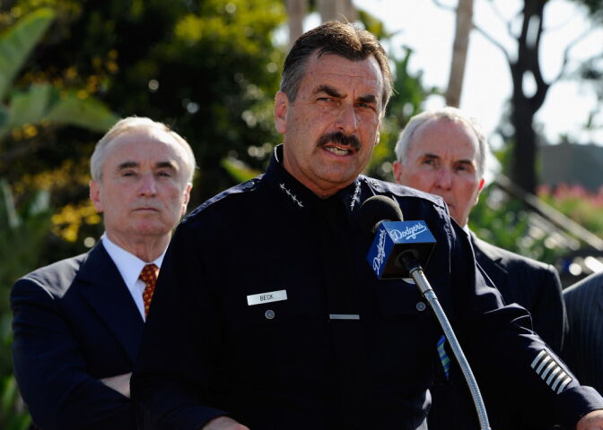 Los Angeles Police Department Chief Charlie Beck (C) speaks during a news conference at Los Angeles Dodger Stadium as Los Angeles Dodgers owner Frank McCourt (R) and former LAPD chief William Bratton listen prior to a game between the St. Louis Cardinals and Los Angeles Dodgers on April 14, 2011 in Los Angeles.