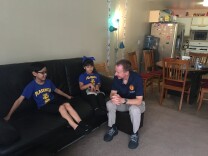 L.A. Unified School District superintendent Austin Beutner speaks with third grader Ricardo Morales (left) and first grader Lilly Morales during a home visit meant to tout the district's newly-expanded attendance push.