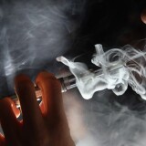 LONDON, ENGLAND - AUGUST 27:  In this photo illustration, a man smokes an E-Cigarette at the V-Revolution E-Cigarette shop in Covent Garden on August 27, 2014 in London, England. The Department of Health have ruled out the outlawing of 'e-cigs' in enclosed spaces in England, despite calls by WHO, The World Health Organisation to do so. WHO have recommended a ban on indoor smoking of e-cigs as part of tougher regulation of products dangerous to children.  (Photo by Dan Kitwood/Getty Images)