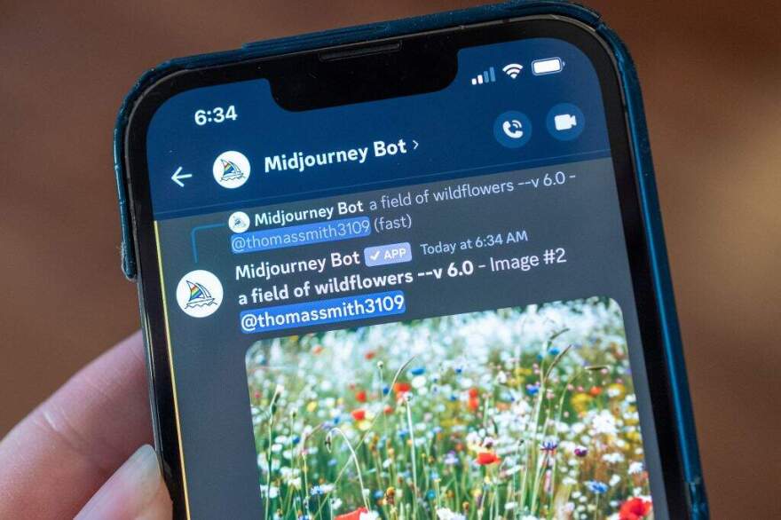Close-up of a person's hand using the Midjourney generative AI image generator in Lafayette, California on May 7, 2024 (Smith Collection/Gado/Getty Images)