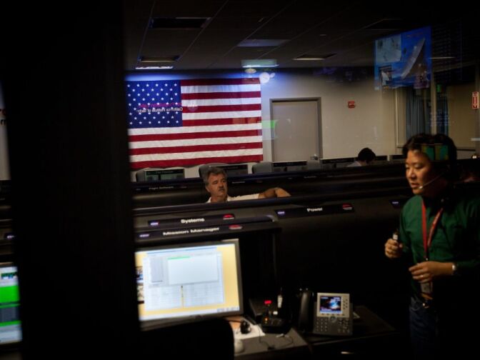 Engineers monitor a telemetry test from the vehicle carrying the Curiosity rover through space in the Mission Support Area of the Jet Propulsion Laboratory in Pasadena.