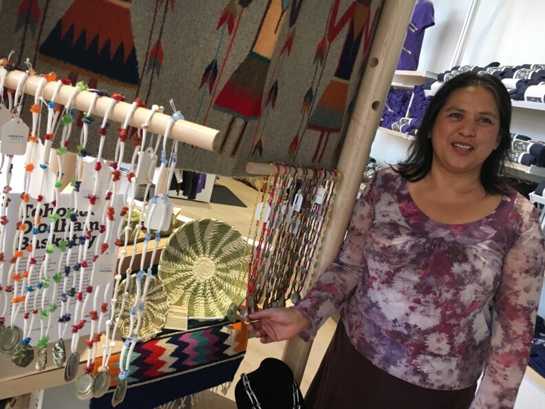 Jilly Canizares, Los Angeles Operations Manager for the Western National Parks Center, Los Angeles, shows off crafts from local Tongva artists at the new Center in downtown L.A.