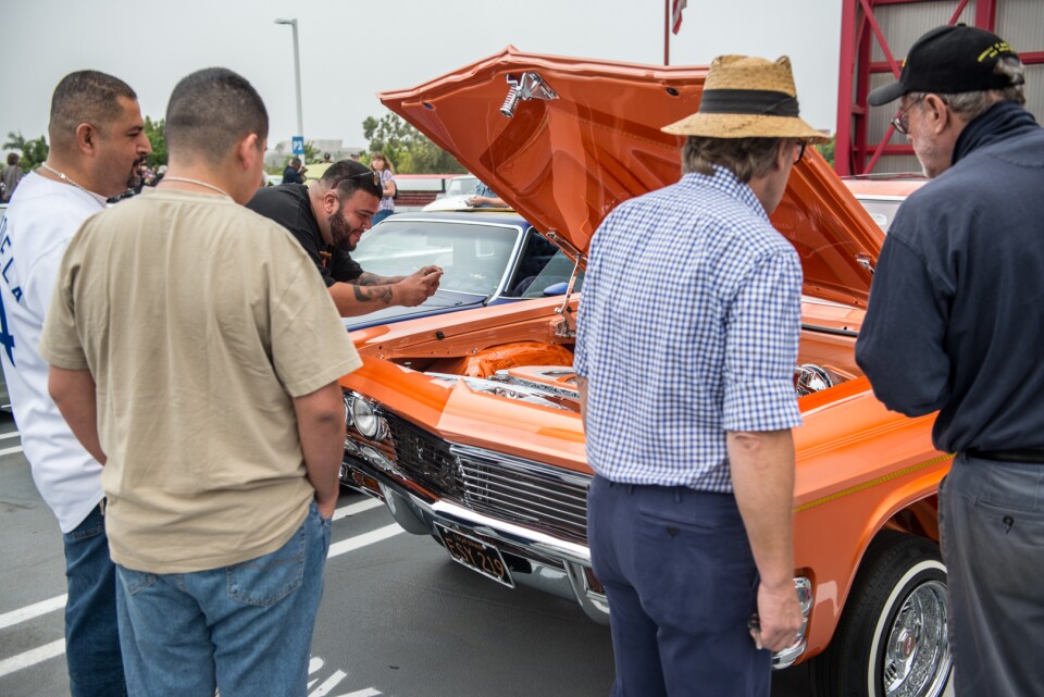 Admirers check out Jesse Saldana's 1965 Chevrolet Impala Super Sport, which won best in show at the Petersen's lowrider gathering.